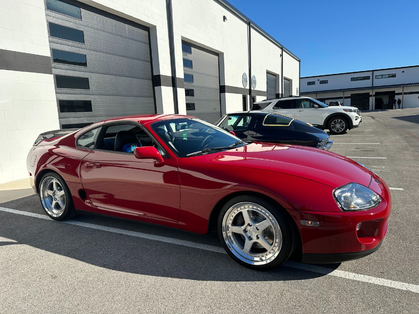 MK4 Supra Exterior After Paint Correction and Coating Red Toyota Supra MK4 side profile after paint correction in Texas sunlight