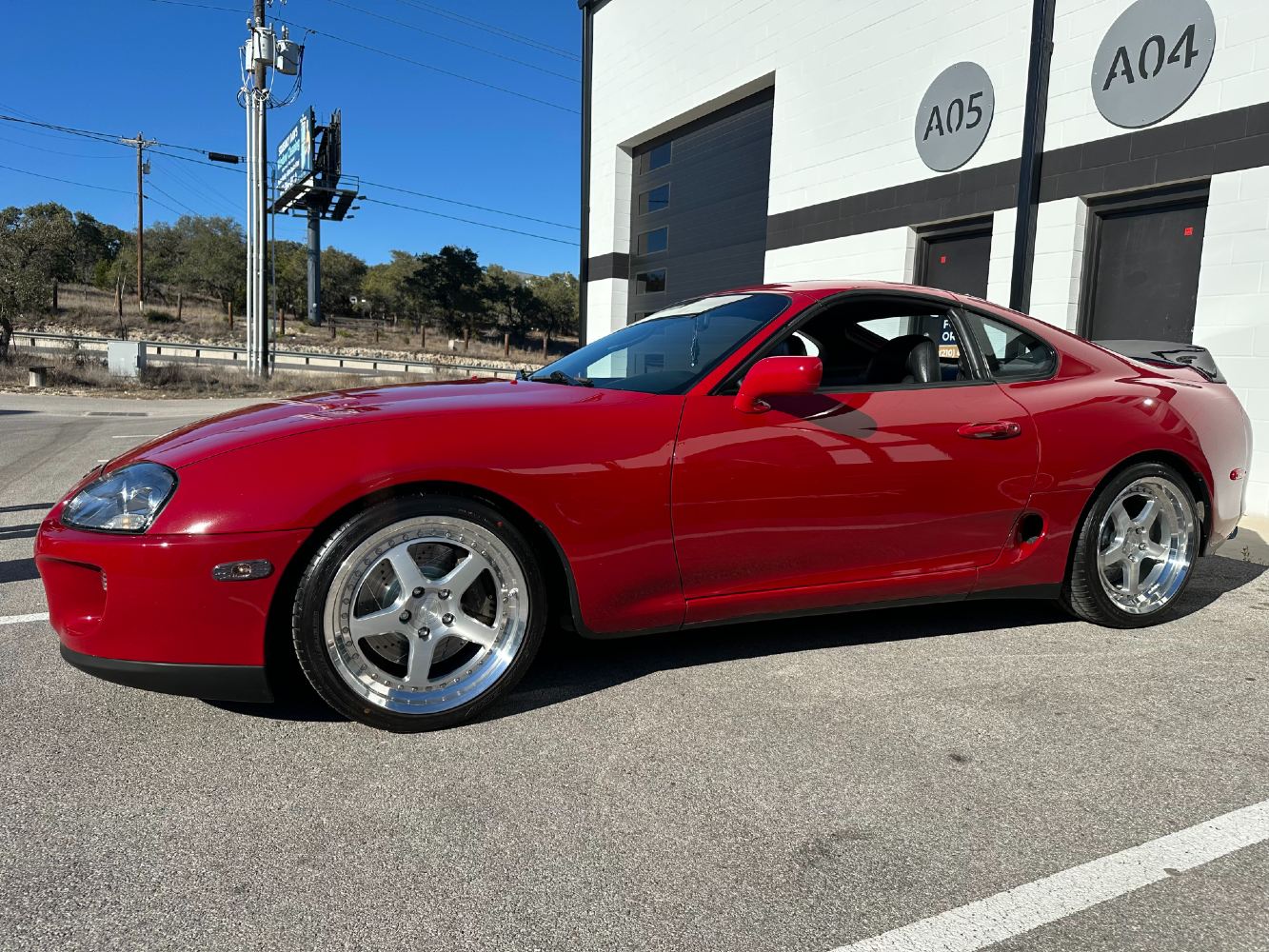 Toyota Supra Side Profile After Professional Refinement Red MK4 Supra with deep gloss finish after two-step buffing process
