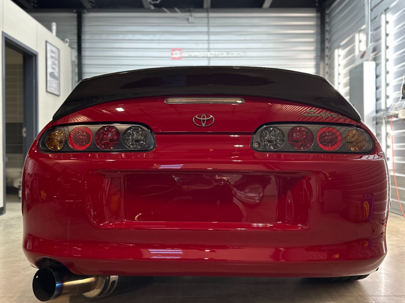 Toyota Supra Rear Finish After Two-Step Paint Correction Red MK4 Supra rear view after professional paint correction and ceramic coating prep