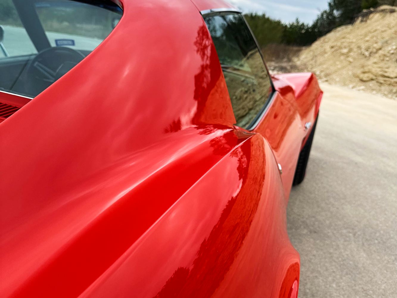 Corvette Quarter Panel Gloss Restoration Close-up of Monza Red Corvette quarter panel after single-stage paint correction