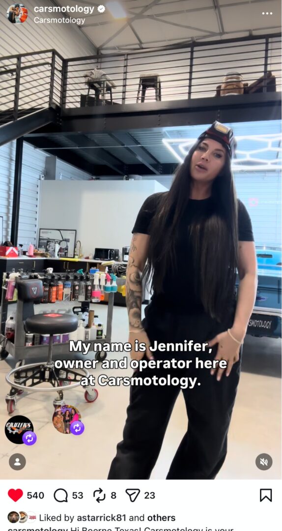 Jennifer, owner of Carsmotology, standing inside the detailing shop.