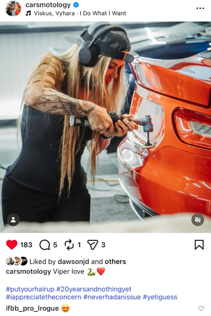Jennifer performing paint correction on a red sports car using a machine polisher.