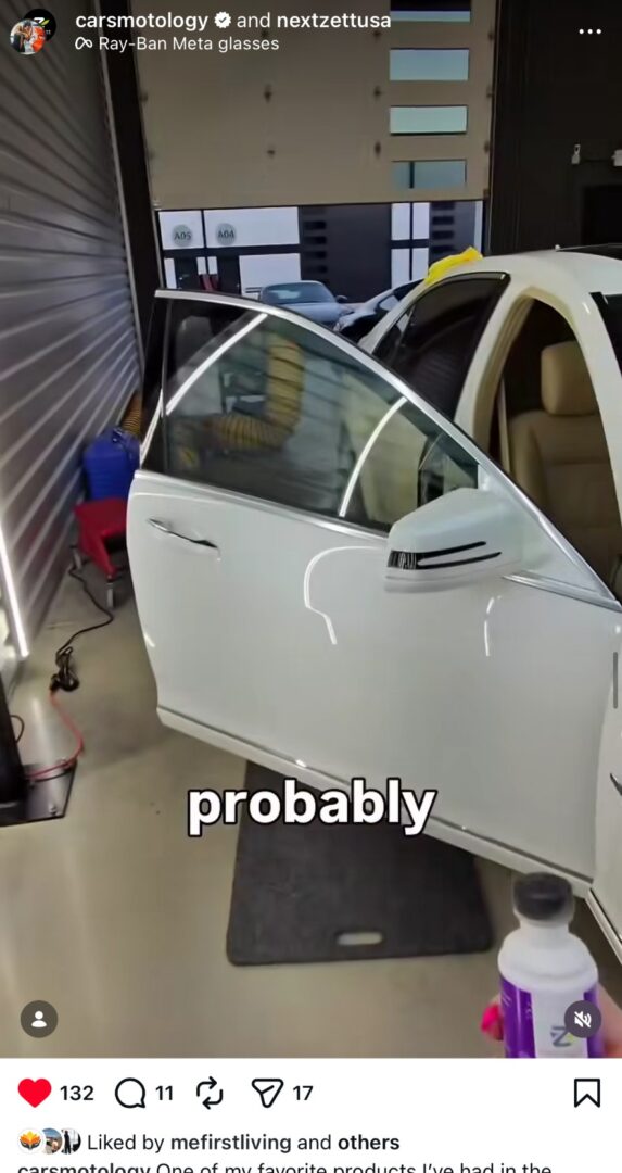 Interior detailing process on a white luxury car inside a detailing shop.