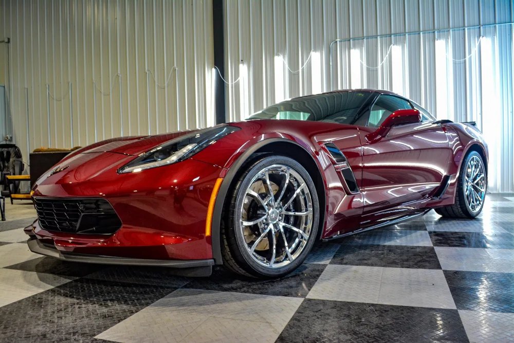 Metallic maroon Chevrolet Corvette with a glossy spray ceramic coating finish at Carsmotology in Boerne, Texas