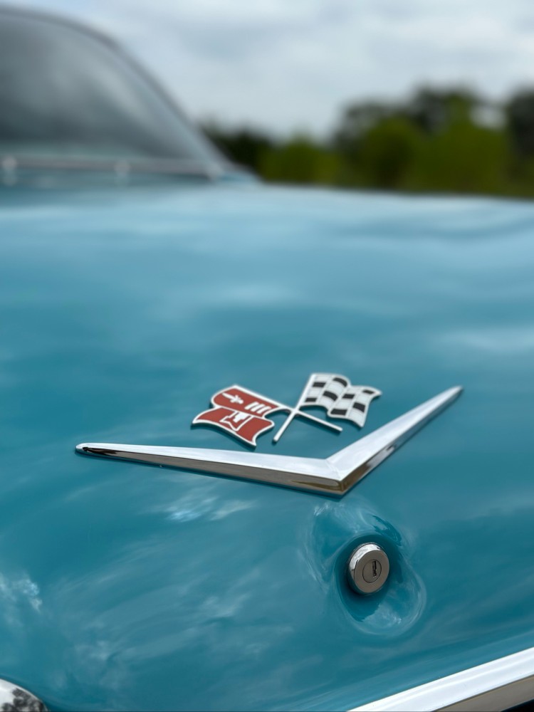 1960 Impala hood emblem detail after paint correction Carsmotology
