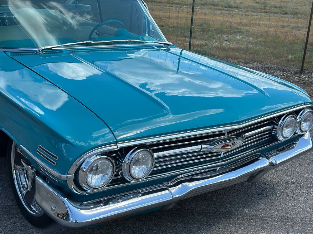 1960 Impala hood reflection showing paint correction results Boerne TX