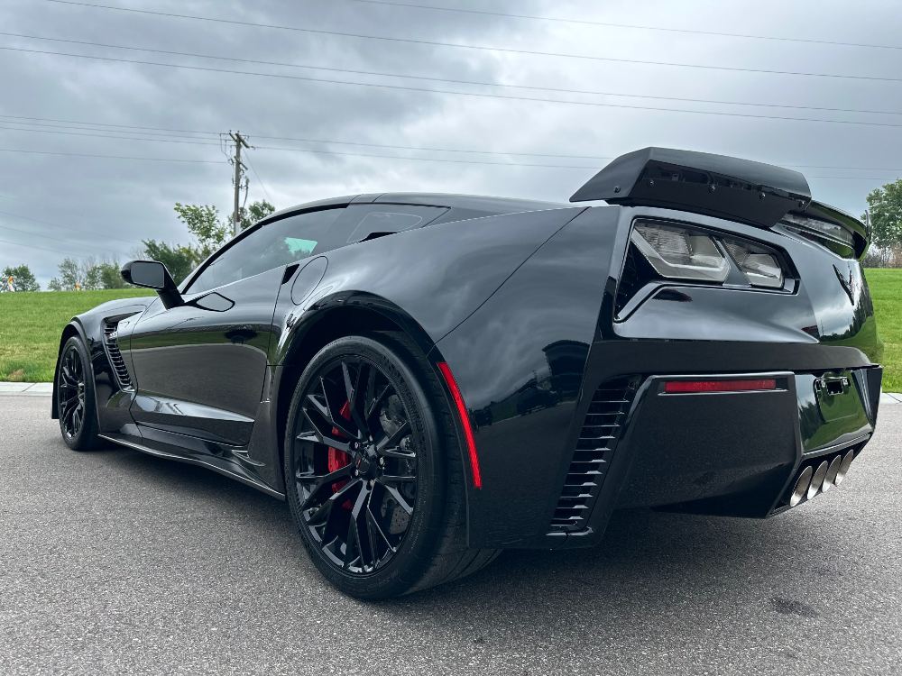 Driver-side rear three-quarter of a black C7 Corvette with a wet-look ceramic coating gloss in Boerne, TX