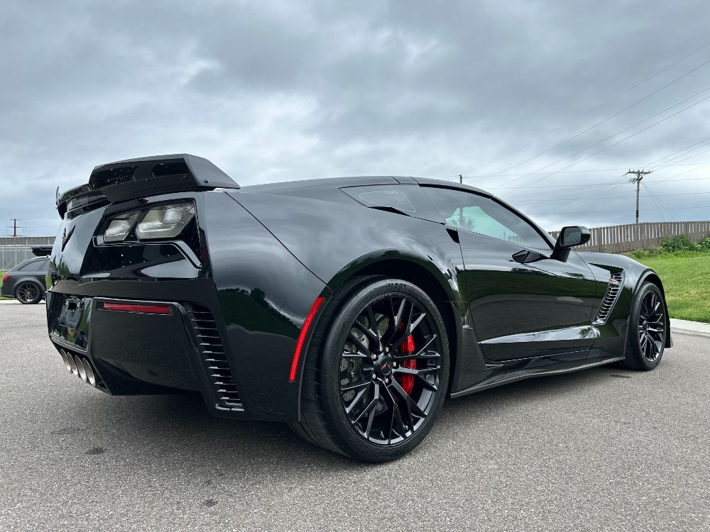 Rear three-quarter of a black C7 Corvette with a deep, glossy IGL ceramic coating finish