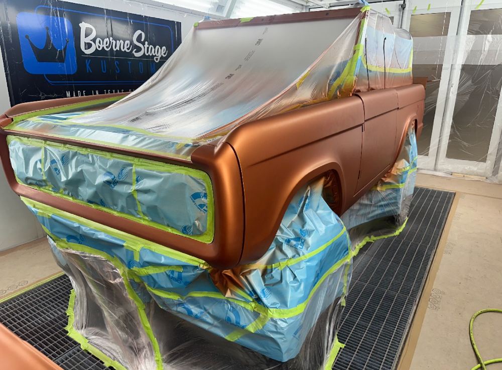 Custom Bronco rear quarter panel masked off in the paint booth at Boerne Stage Kustoms during Axalta paint application