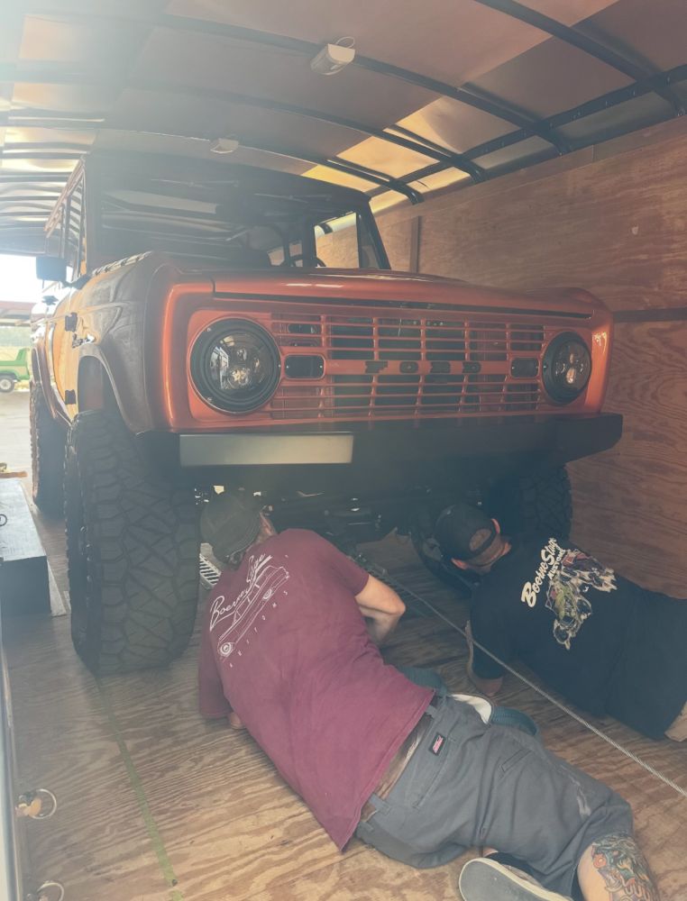 Front grille and round headlights of the finished burnt-orange custom Ford Bronco with FORD lettering