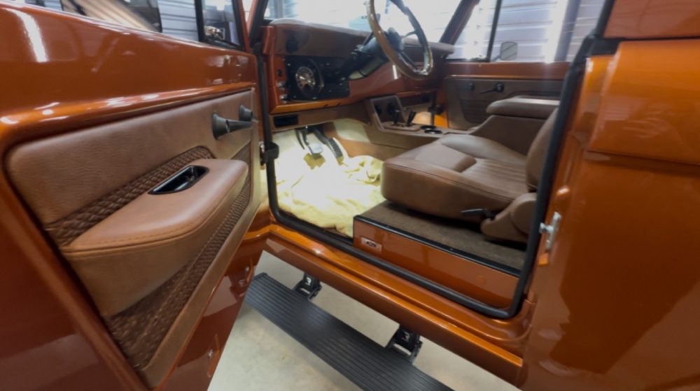 Paint protection film tucked seamlessly into the door jamb of the custom Bronco so the film edge is hidden under the door gasket