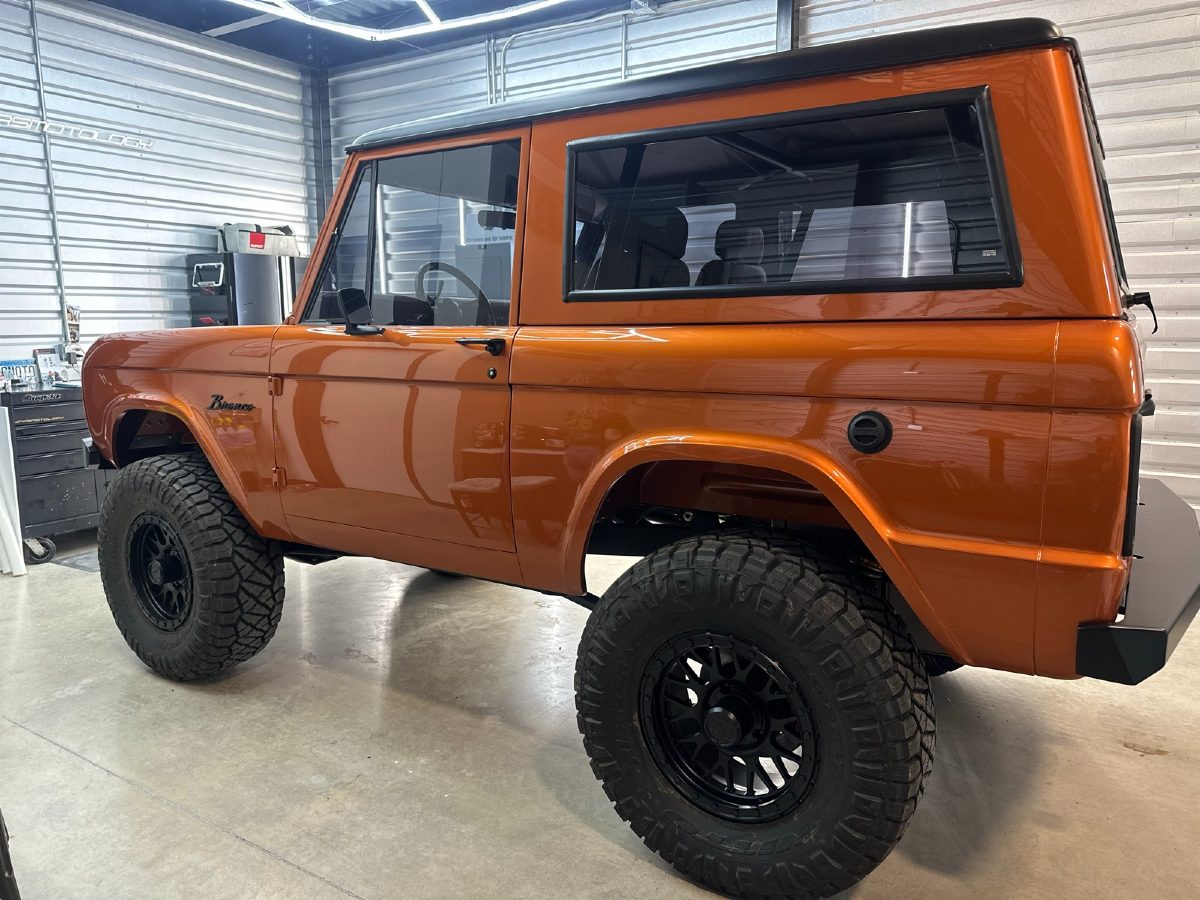 Finished burnt-orange custom Ford Bronco with a satin-black top and paint protection film, built by Boerne Stage Kustoms and protected by Carsmotology in Boerne, TX