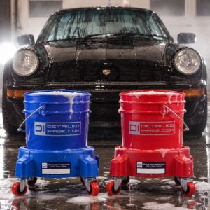 Blue and red wash buckets on DI bucket dollies in front of a foamed-up black Porsche