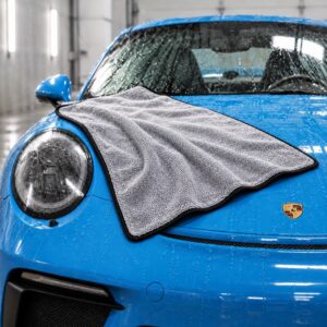Griot’s Garage PFM Terry Weave Drying Towel draped over the hood of a wet blue Porsche