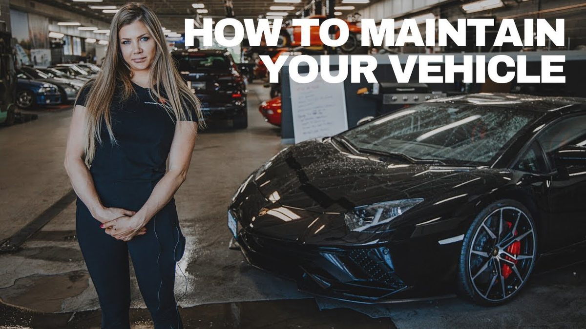 Jennifer of Carsmotology standing beside a black Lamborghini in a detailing shop, explaining how to maintain a ceramic coating