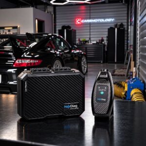 NexDiag NexPTG Pro Carbon paint thickness gauge and carbon fiber case in the Carsmotology shop with a black Porsche