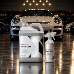 NXTZEN Easy Dry ceramic drying aid 500ml bottle and 5 liter container in front of a white Porsche 911