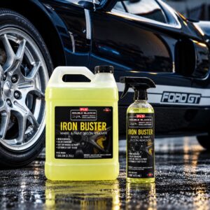 P&S Iron Buster iron and fallout remover bottle and gallon in front of a black Ford GT and wheel